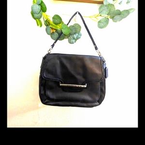 Coach 'Taylor' black leather handbag with shiny trim.